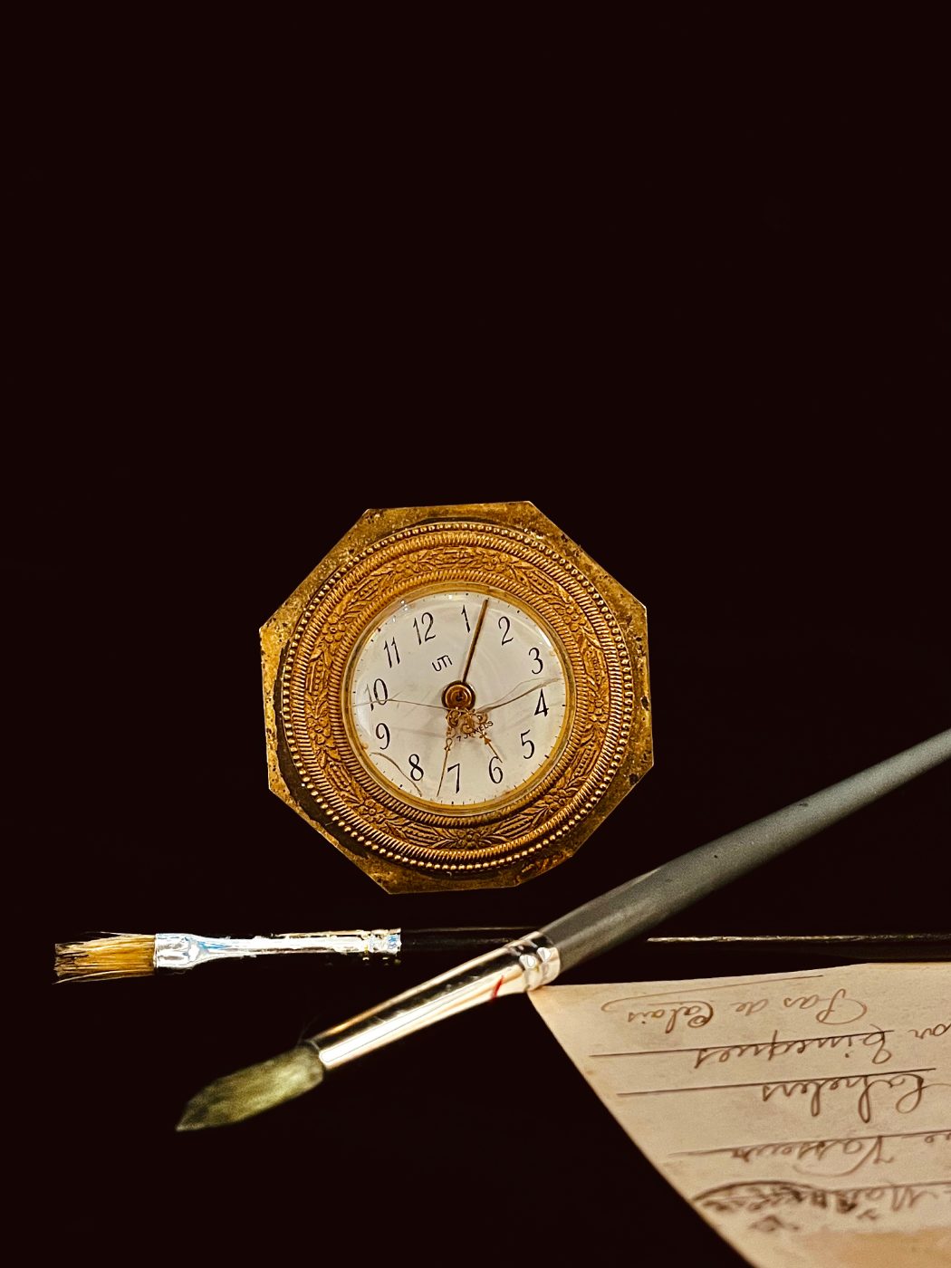Antique clock with paintbrushes