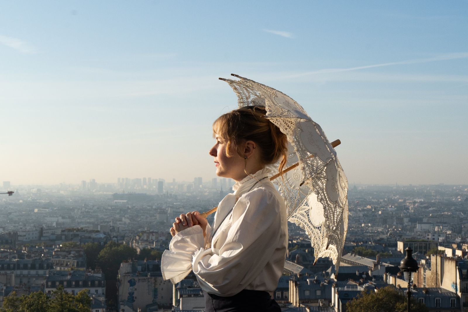 Miss Time Traveler with her parasol above the rooftops of Paris